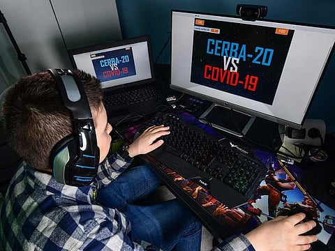 Fourth grade pupil 9-year-old boy Lupo Daturi displays 'Cerba-20', the online video game to virtually combat COVID-19 that he built from scratch during lockdown.