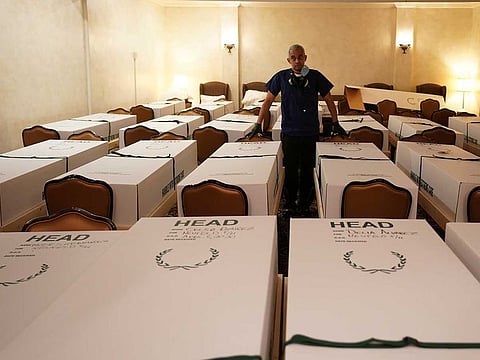Funeral Director Omar Rodriguez looks over caskets of bodies at the Gerard J. Neufeld funeral home during the outbreak of the coronavirus disease (COVID-19) in the borough of Queens, New York, US