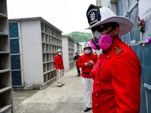 Firefighters attend the funeral of chief Luis Paez after he died of the coronavirus disease and whose wife died of the same reason a few days earlier, in Guayaquil, Ecuador. 