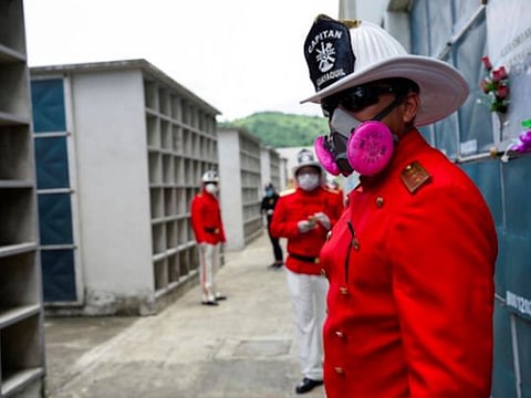 Firefighters attend the funeral of chief Luis Paez after he died of the coronavirus disease and whose wife died of the same reason a few days earlier, in Guayaquil, Ecuador. 
