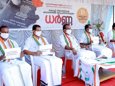 Parliamentarians and state legislators sit in protest seeking the return of stranded Indian nationals abroad, in front of Nedumbassery International Airport Kochi in Ernakulam on Monday.
