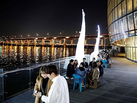 People enjoy drinks amid concerns about the spread of the coronavirus disease (COVID-19), at Han River park in Seoul, South Korea, April 29, 2020.