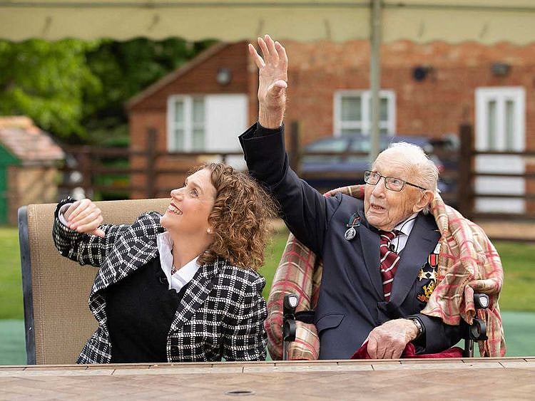 Second World War veteran Captain Tom Moore with his daughter Hannah walk garden