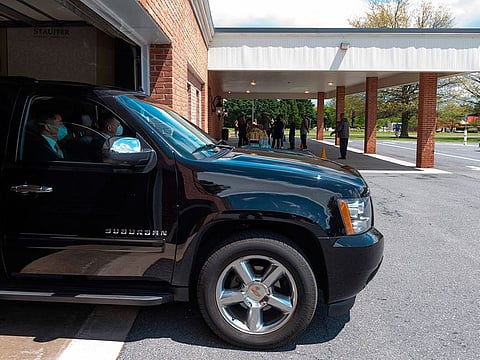 Funeral home staff back into a garage to deliver the body of a COVID-19 victim in Maryland,