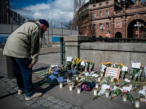 A memorial in Stockholm's Mynttorget square, on April 29, 2020, in memory of loved ones lost to the coronavirus featuring candles, flowers and handwritten notes