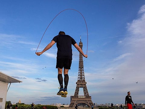 A man exercises along Trocadero Square, close to the Eiffel Tower, Saturday, May 2, 2020, in Paris. France continues to be under an extended stay-at-home order until May 11 in an attempt to slow the spread of the coronavirus pandemic.