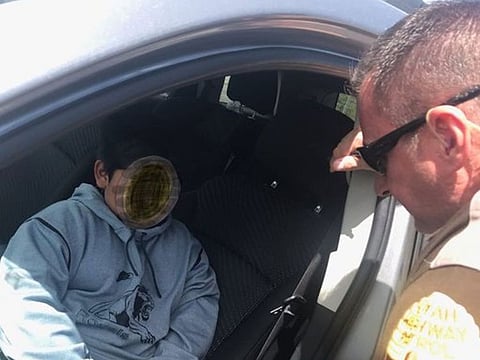 A trooper is shown speaking to a 5-year-old boy who was pulled over on in Ogden Monday, May 4, 2020, in a photograph altered by the Utah Highway Patrol.