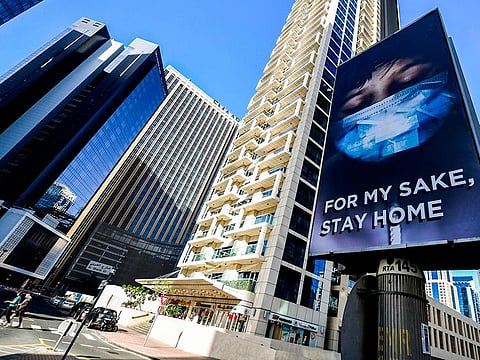 A view of an advertisement board on display in a street in Dubai, advising residents to remain at home.  