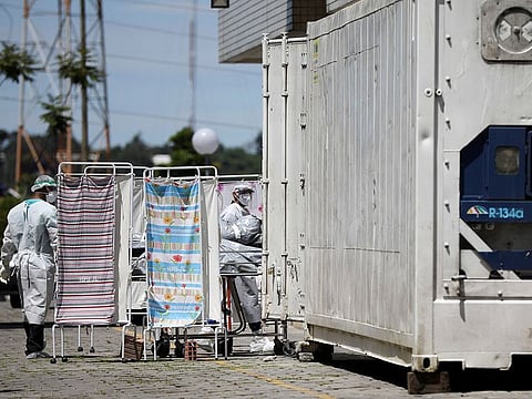Healthcare workers wearing protective gear transport the body of a person to a refrigerated truck during the coronavirus disease (COVID-19) outbreak, at the Dr. Joao Lucio Pereira Machado hospital in Manaus, Brazil April 21, 2020. 