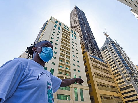 A resident pointing to Abbco Tower which caught fire