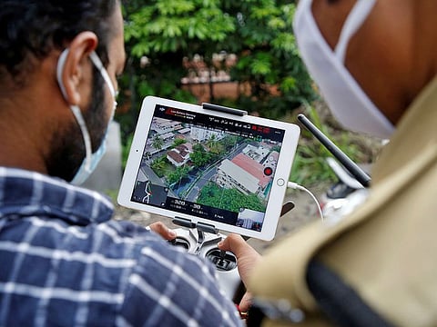 Police officers use a drone to monitor the movement of people in a residential area after the area was declared a hot spot by government officials during a nationwide lockdown to slow the spreading of the coronavirus disease (COVID-19) in Kochi, India, April 24, 2020