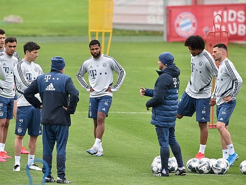 Bayern Munich's head coach Hansi Flick (centre) talks to his players during a training session on May 5. Bundesliga will be the first of the major European leagues to resume on May 16.
