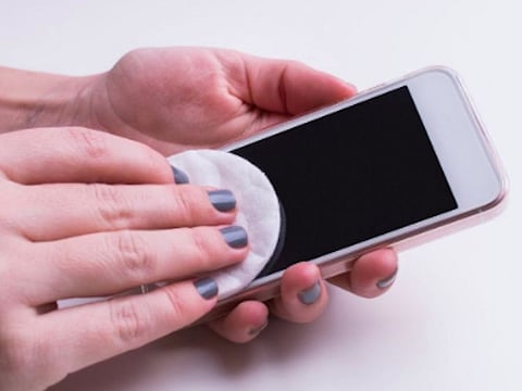 Illustrative image: A person cleaning a phone screen