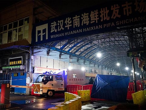 File photo: Wuhan Hygiene Emergency Response Team staff leave the closed Huanan Seafood Wholesale Market in Wuhan on January 11, 2020.