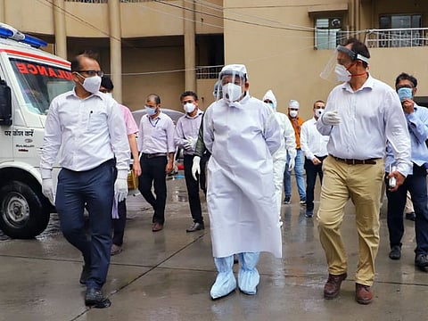 India's Union Health Minister Harsh Vardhan wearing protective kit inspects the Covid care centre in Mandoli area at Shahdara, in New Delhi on Sunday. 