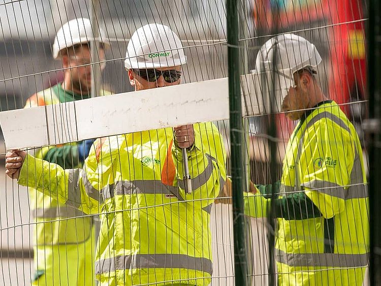 UK Construction workers erect fencing on London Bridge in London