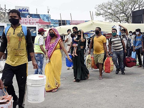 Migrants arrive on a Sharamik special train at Danapur Station amid COVID-19 pandemic, in Patna on Tuesday. 