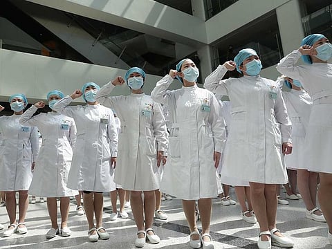 Nurses wearing face masks take part in an event held to mark the International Nurses Day, at Wuhan Tongji Hospital in Wuhan, the Chinese city hit hardest by the coronavirus disease (COVID-19) outbreak, in Hubei province, China May 12, 2020. 