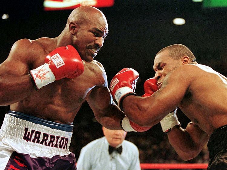 Evander Holyfield connects to the jaw of Mike Tyson in the first round of their title fight June 28 1997. Evander Holyfied retained his World Boxing Association heavyweight title on Saturday night when Mike Tyson was disqualified for biting Holyfield twice in the third round.