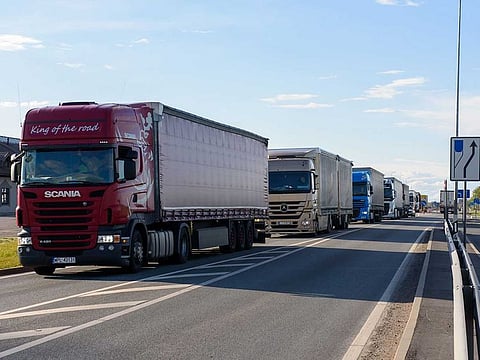 Trucks wait in a queue at the Latvia-Lithuania border crossing in Grenctale, Latvia on May 14, 2020, ahead of border reopening. After two months of coronavirus-related restrictions, the Baltic States agreed to lift travel restrictions and ensure free movement of their residents by land, sea and air: the so-called 'Baltic Bubble' from May 15, 2020. 