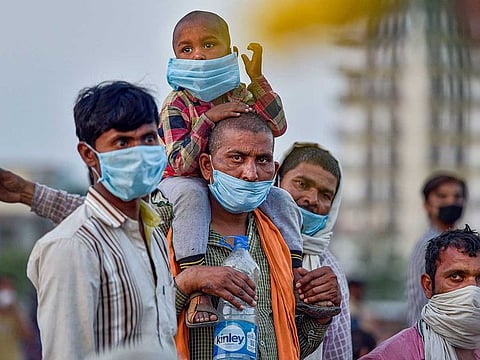 Migrants at Ghazipur border on their way to their native places, during ongoing COVID-19 lockdown, in New Delhi, Friday, May 15, 2020. 