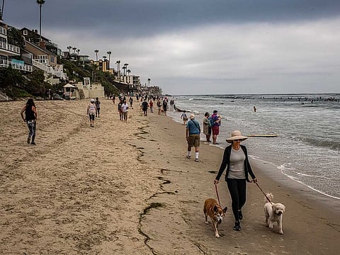Crowds on the shoreline in Laguna Beach, California, May 9, 2020. The costs of the shutdown, economic and otherwise, have driven many people to the breaking point. But governors are increasingly worried about the costs of reopening, too. 
