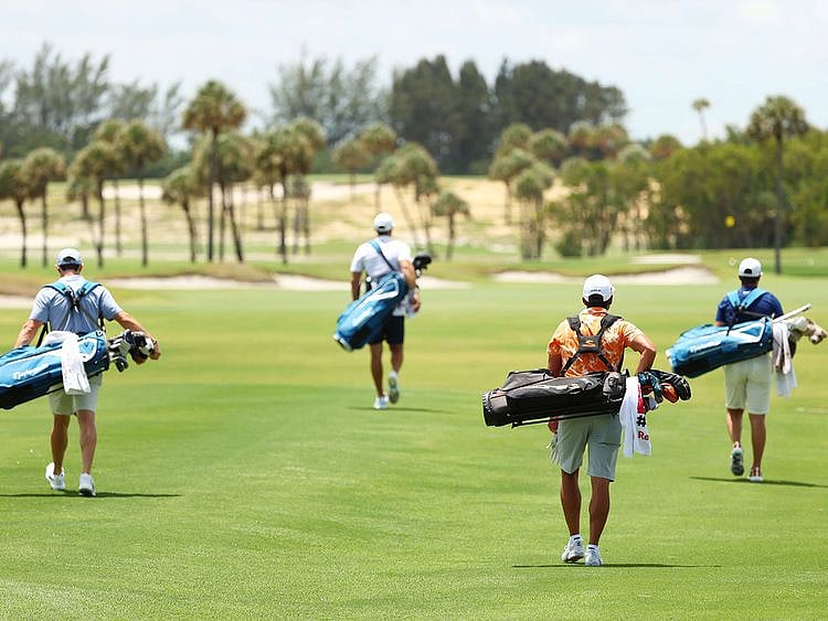 From left: Rory McIlroy and Dustin Johnson of the American Nurses Foundation team, and Rickie Fowler and Matthew Wolff of the CDC Foundation team carry their own bags on the fanless course.