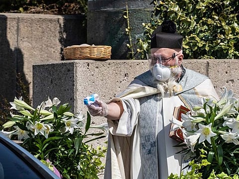 Priest uses squirt gun with holy water