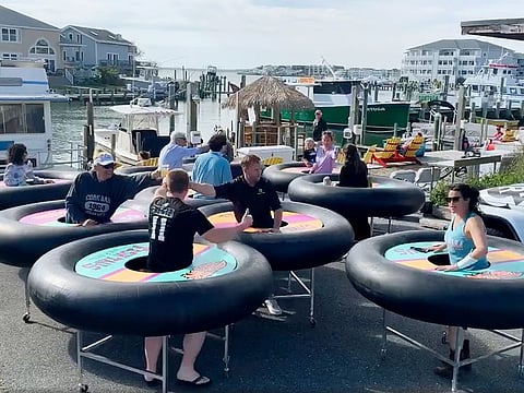 "Bumper tables" allow people to practice social distancing while eating and talking, are debuted at Fish Tales, a restaurant in Ocean City, Maryland.  