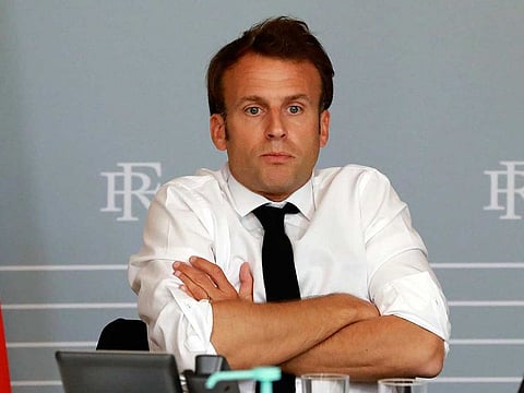 In this May 6, 2020 file photo, French President Emmanuel Macron reacts during a video conference with artists from different fields at the Elysee Palace in Paris. France's ruling party has lost its absolute majority at France's lower house of parliament, in a symbolic blow to President Emmanuel Macron's leadership amid the coronavirus crisis. 