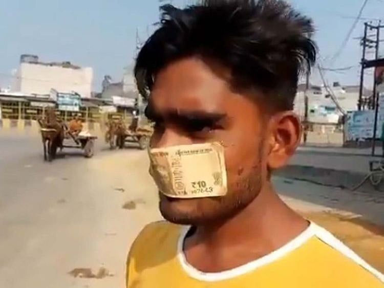 Man wears bank note as a mask