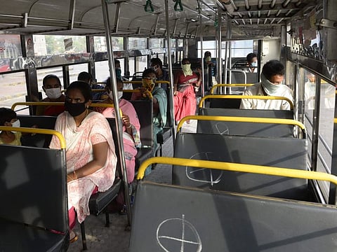 Passengers maintain social distancing as they sit inside a bus as Telangana State Road Transport Corporation (TSRTC) resumed bus services after the government eased lockdown 