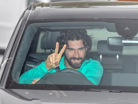 Liverpool's Brazilian goalkeeper Alisson Becker arrives at Melwood in Liverpool, north west England for a training session on May 19, 2020, as training resumes for the first time since the English Premiere League was halted due to the COVID-19 pandemic. / AFP / Paul ELLIS