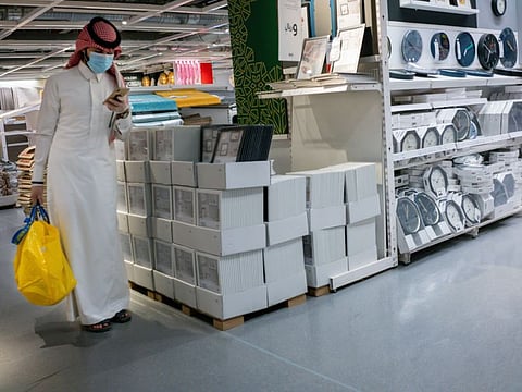 A customer wears a protective face mask while shopping in Riyadh on May 19. 2020. Before the pandemic, most shops, pharmacies and gas stations in the kingdom halted for at least 30 minutes for each prayer session, the only country that enforced such closures.