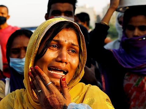 A migrant woman cries as her and others were stopped from crossing the border, during an extended nationwide lockdown to slow the spread of the coronavirus disease (COVID-19), in New Delhi, India, May 15, 2020. 