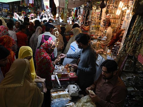 Women shop at a jewellery store at Baghbanpura Bazar ahead of Eid Al Fitr in Lahore on May 21, 2020. 