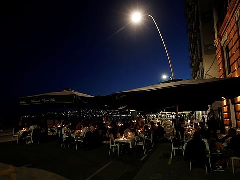 People sit at a reopened restaurant on the waterfront, as Italy eases some of the lockdown measures put in place during the coronavirus disease (COVID-19) outbreak, in Naples, Italy May 21, 2020.