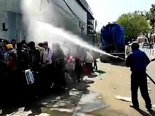 Watch: Migrants waiting for medical screening sprayed with disinfectant in New Delhi