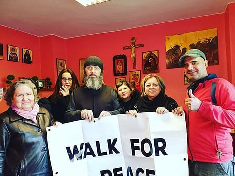 Briton Farid Feyadi (extreme right) with a family in Greece en route to Mecca from