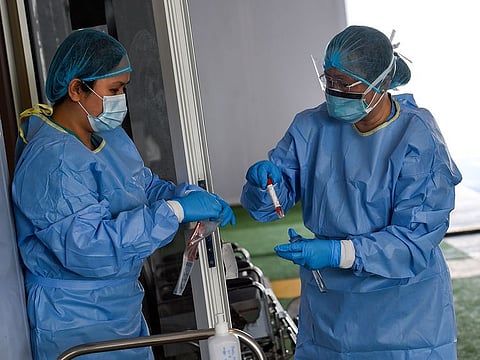Paramedics store the swab sample at the SEHA drive through National Screening Center in Sharjah. 