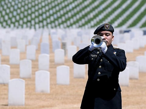 Alexander Hernandez plays his trumpet on Memorial Day at the Los Angeles National Cemetery on May 25, 2020 in Los Angeles, California. 