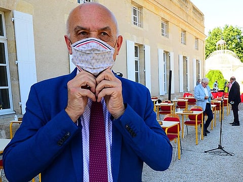 Mayor of Gradignan Michel Labardin poses with a protective face mask before a municipal council meeting on his reelection and of his deputies, at Parc Laurenzanne in front of the Hotel de Ville in Gradignan, near Bordeaux, southwestern France, on May 25, 2020.