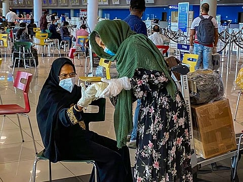 750 stranded Indian nationals wait to board Air India flights at an airport as the government has arranged four flights to Kochi, Kannur, Kozhikode and Trivandrum to evacuate them under Vande Bharat mission, in Dubai. 