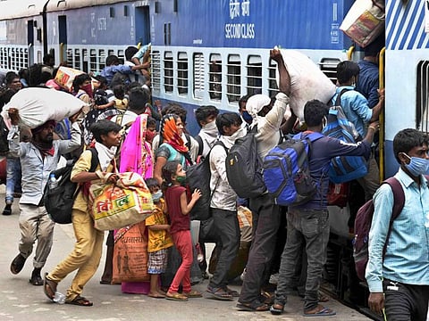 Migrant labourers board a 'Shramik Special' train at Danapur railway station in Bihar to reach their native places. 