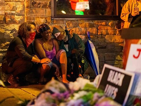 Shawanda Hill (C), the girlfriend of George Floyd reacts near the spot where he died while in custody of the Minneapolis Police, on May 26, 2020 in Minneapolis, Minnesota.  