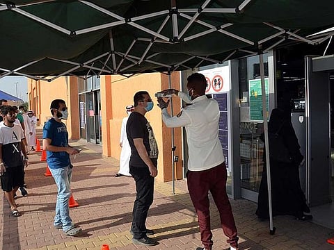 File picture: Shoppers queue up outside a mall in the Saudi city of Medina.