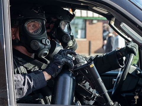 Detroit Police in riot gear sit in a police SUV during a demonstration in Detroit, Michigan, on May 29, 2020 over the death of George Floyd, a black man who died after a white policeman kneeled on his neck for several minutes. 