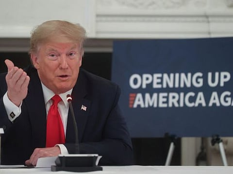 US President Donald Trump speaks during a roundtable discussion with industry executives on reopening businesses during the COVID-19 pandemic in the State Dining Room at the White House in Washington, on Friday.  
