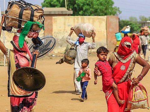 Migrants shift to a shelter home in a village before leaving for their native places in special buses, arranged by the Rajasthan government, during ongoing COVID-19 lockdown in Jaipur, India, on May 29, 2020.