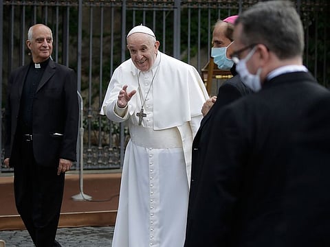 Pope Francis waves as he leaves after a rosary in Vatican gardens Saturday, May 30, 2020.